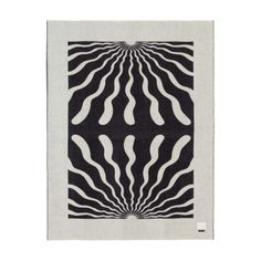 a black and white rug with an abstract design on the bottom, in front of a white background