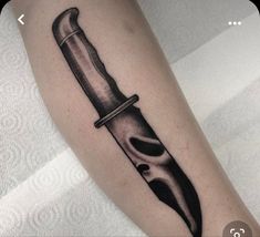 a knife with a skull on it is shown in black and white tattoo art work