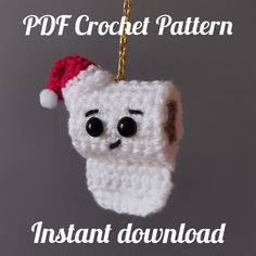 a crocheted ornament with a santa hat hanging from it's side