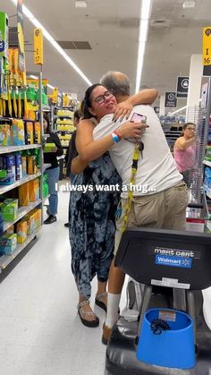 two people hugging each other while shopping in a grocery store with shelves full of products