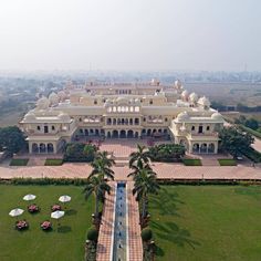 an aerial view of a large building with many lawns and umbrellas