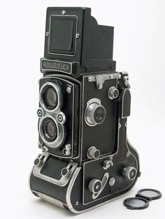 an old fashioned camera sitting on top of a table