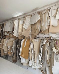 there are many clothes hanging on the wall