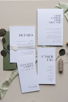 the wedding stationery is laid out on top of each other