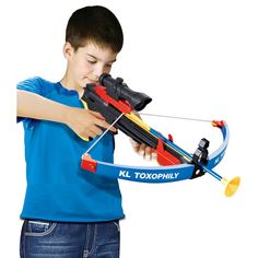 a young boy is playing with a toy bow and arrow that says klx trophy