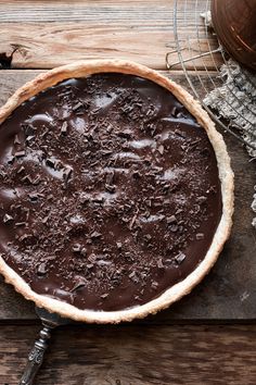 a chocolate pie sitting on top of a wooden table