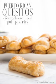 a plate full of croissants sitting on top of a table next to other pastries