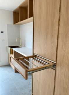 Pull out clothes drying rack in custom cabinetry Hamper In Cabinet, Laundry Ceiling Drying Rack, Laundry Room Custom Cabinets, Modern Laundry Rooms Luxury, Laundry Joinery, Japandi Laundry Room, Mid Century Laundry Room, Built In Laundry, Hidden Laundry Rooms