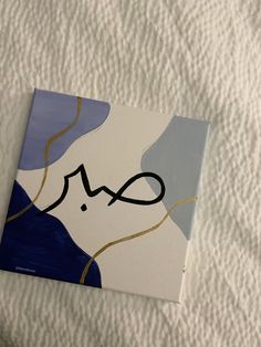 an abstract painting with the word love in black ink on a white sheet that has blue and gold lines