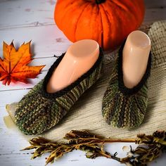 a pair of slippers sitting on top of a table next to a pumpkin