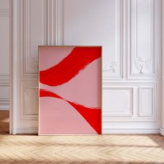 an empty room with a red and pink painting on the wall next to a wooden floor