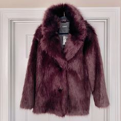 Description Luxurious, Cozy And Versatile, This Faux Fur Coat Promises To Be A Show-Stopping Last Layer Every Time. Throw It On Over Any Look For Instant Glam. Features & Fabric Oversized Notch Lapels; Two Button Front Long Sleeves Faux Fur; Hand Pockets Lined; Straight Hem Acrylic/Polyester Chic Burgundy Outerwear For Winter, Chic Burgundy Winter Outerwear, Burgundy Long Coat For Fall, Burgundy Long Coat For Winter, Embellished Coat, Evening Coat, Ruched Sleeve Blazer, Vintage Jean Jacket, Black Puffer Vest