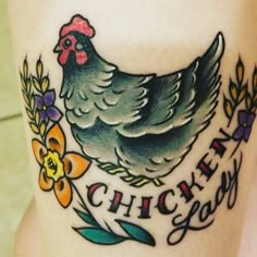 a chicken tattoo on the side of a woman's leg that says, chick you