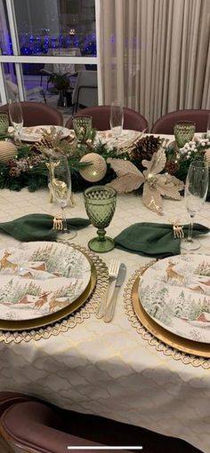 the table is set with plates and place settings