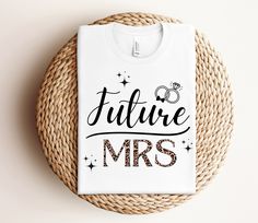 a white t - shirt with the words future mrs printed on it next to a woven basket