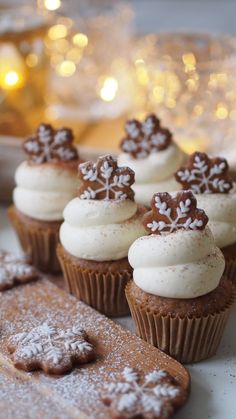 some cupcakes with frosting and decorations on them sitting next to a cookie