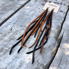 -These boho tassel earrings are made from soft black and rust-color deerskin leather.  Part Cowgirl, part Biker, part Rock & Roll, the tassel earrings give a big kick to any outfit.-Dramatic but lightweight enough to wear every day. -9" total length.-Earwires are antique-brass.  Goldfill earwires are available by request. -Deerskin leather is sustainably sourced in the USA.-Ok to get wet.-Available in 14 colors.-Designed and handmade in South Pasadena, CA.Check out more of our lovely earring Brown Tassel Earrings For Festivals, Brown Fringe Tassel Earrings For Festivals, Bohemian Black Tassel Earrings As Gift, Black Tassel Earrings For Festival, Black Statement Earrings, Shoulder Duster Earrings, Diy Leather Earrings, Edgy Jewelry, South Pasadena