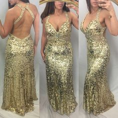 a woman in a gold sequin dress taking a selfie