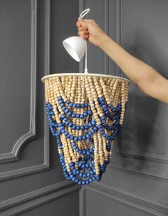 a chandelier made out of corn and blue beads