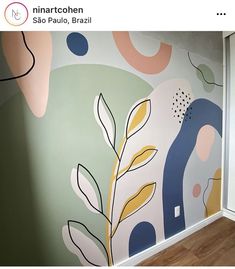 the wall is painted with different colors and shapes