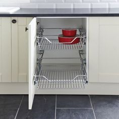 an open cabinet in the middle of a kitchen