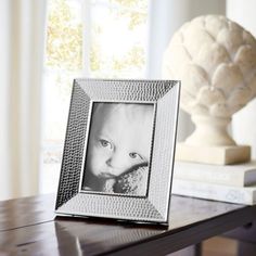 a silver frame sitting on top of a wooden table