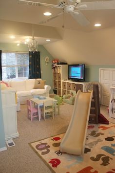 a child's playroom with a slide in the middle