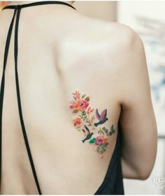 the back of a woman's shoulder with flowers on it