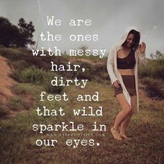 a woman standing on top of a lush green field next to a forest with an inspirational quote above her