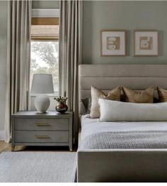 a bedroom with a bed, nightstand and window