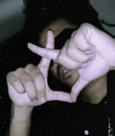 a person making the peace sign with their fingers