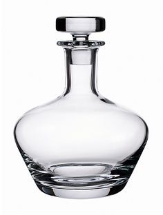 a clear glass bottle with a silver stopper on the top is sitting in front of a white background