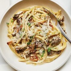 a white bowl filled with pasta and mushrooms