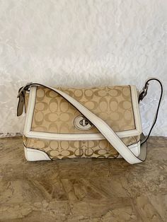 Coach Hampton Beige Leather Cross-body Shoulder Bag  COLOR: khaki, red MATERIAL: canvas/jacquard and  leather HARDWARE: Nickel  SERIAL NUMBER: F13972 CLOSURE: Flap, buckle, snap on EXTERIOR POCKETS: Back open pocket HANDLE: single, detachable, expandable or convertible  DETAILS: Vtg Hampton, light stitching  INTERIOR: pink grossgrain fabric MEASUREMENTS:  11.25"L X 8.25"H X 3.25"D. Classic Coated Canvas Satchel With Flap, Classic Coated Canvas Flap Satchel, White Monogram Canvas Bag With Adjustable Strap, Crossbody Shoulder Bag With Leather Trim, Beige Signature Coated Canvas Shoulder Bag For Everyday Use, White Monogram Canvas Satchel Shoulder Bag, Beige Coated Canvas Crossbody Shoulder Bag, Designer Beige Shoulder Bag In Signature Coated Canvas, Designer Beige Shoulder Bag In Coated Canvas