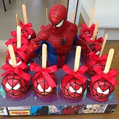 a spiderman themed cake with candles and candies