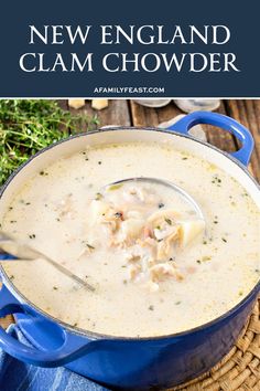 a blue pot filled with clam chowder on top of a wooden table