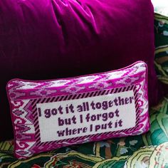 a purple pillow sitting on top of a colorful couch next to a pink pillow with the words, got it all together but i forgot where i put it