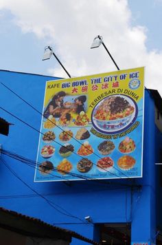 a blue building with a large sign on it's side that says kafe big bowl city of ice