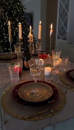 the table is set with candles and plates