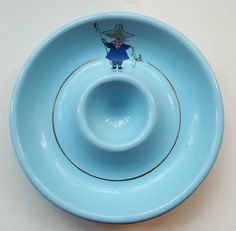 a blue bowl with an image of a man holding a golf club on the side