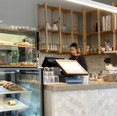 a man behind the counter in a bakery