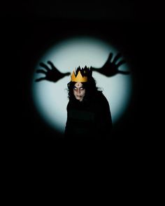 a woman wearing a crown in the dark