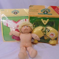 a toy doll is sitting next to its packaging