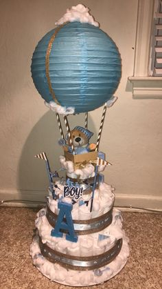 a birthday cake made to look like a hot air balloon with the number four on it