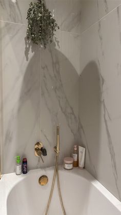 a white bath tub sitting next to a shower head