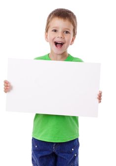 a young boy holding up a white sign with his mouth wide open and smiling at the camera