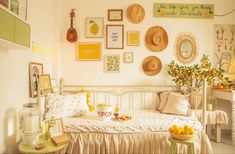 a white bed sitting in a bedroom next to a table with fruit on top of it