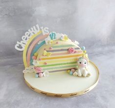 there is a cake that has been decorated with rainbows and unicorns on it