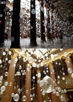 two pictures of the inside of a building with lights hanging from it's ceiling