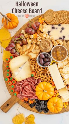 a wooden platter filled with cheese, crackers and other foods on top of it